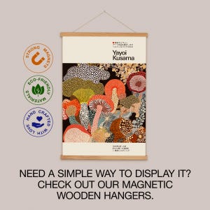 Infographic promoting pairing the Yayoi Kusama-inspired poster with a magnetic wooden hanger. Displays the poster on a natural wood hanger.