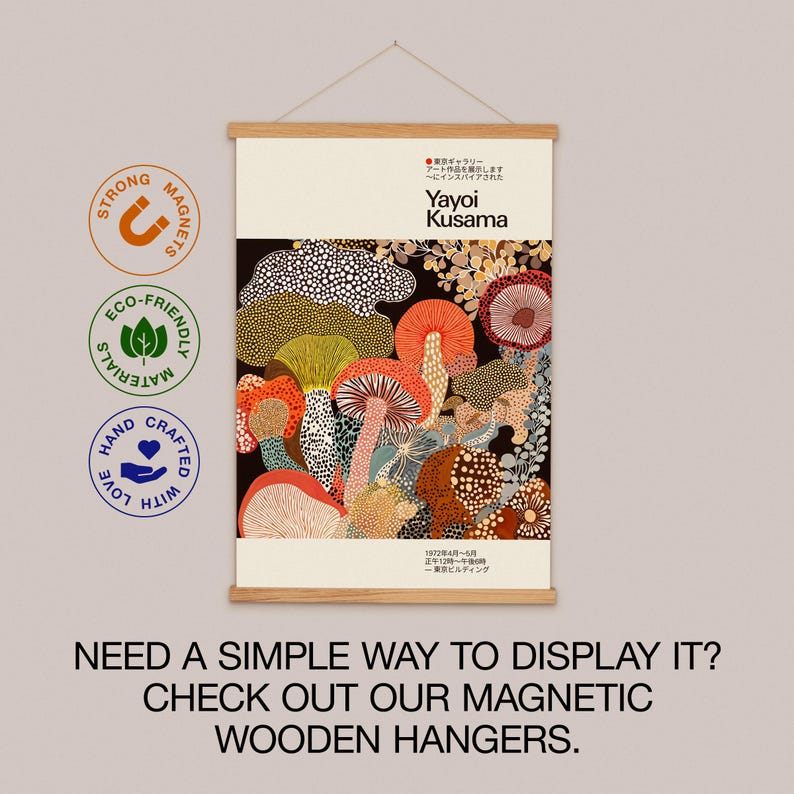 Infographic promoting pairing the Yayoi Kusama-inspired poster with a magnetic wooden hanger. Displays the poster on a natural wood hanger.
