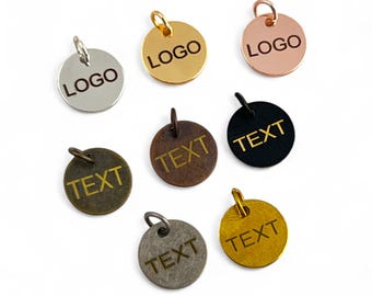 May include: Assortment of seven round metal tags with a hole at the top for hanging. The tags are in various finishes, including silver, gold, copper, brass, and black. The tags are engraved with the words "LOGO" and "TEXT".
