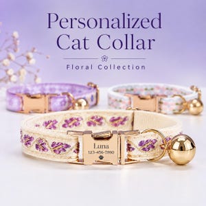 May include: Three cat collars with gold-toned metal buckles and bells. The front collar is cream-colored with purple floral embroidery and a buckle engraved with the name Luna, a phone number, and a paw print. Text reads Personalized Cat Collar.