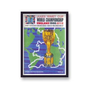 May include: Framed vintage poster for the 1966 World Championship in England. The poster features a gold trophy, a map of England in green, and text that reads "JULES RIMET CUP WORLD CHAMPIONSHIP ENGLAND 1966 JULY 11-30".