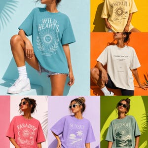 May include: Collection of oversized t-shirts in various colors, each featuring unique graphic designs. The shirts display text and illustrations, including "Wild Hearts," "Sunset Club," and "Paradise." The shirts are styled with shorts and sunglasses.