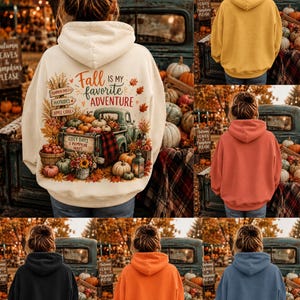 May include: A cream-colored hooded sweatshirt featuring a graphic on the back of a vintage truck filled with pumpkins, sunflowers, and autumn leaves, with the text "Fall is my favorite ADVENTURE" and signs reading "PUMPKIN PATCH," "HAYRIDES," and "APPLE CIDER."
