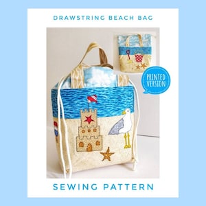 Op de afbeelding: Naai-patroon voor een trekkoordstrandtas met een zandkasteel-, meeuwen- en zeester-ontwerp. De tas is gemaakt van beige stof met blauwe en witte accenten. Het patroon bevat instructies voor het maken van de tas en een geprinte versie van het ontwerp.