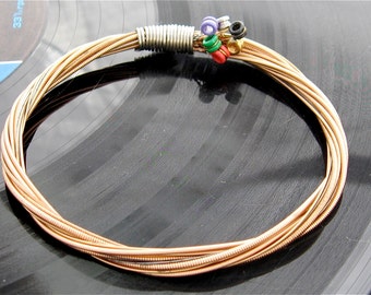 Acoustic Guitar String Bracelet bronze colored with colored ball ends attached UNIQUE Portion of proceeds go to youth music scholarships