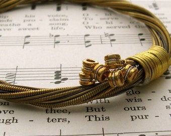 Recycled Acoustic Guitar String Bracelet gold colored with colored ball ends attached Mens or Womens Front Page