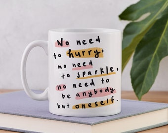 May include: White ceramic mug with a black and yellow quote that reads "No need to hurry, no need to sparkle, no need to be anybody but oneself."