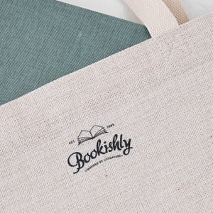 May include: A white canvas tote bag with a black logo that says "Bookishly" and "Est. 2009" with the text "Inspired by Literature" underneath.