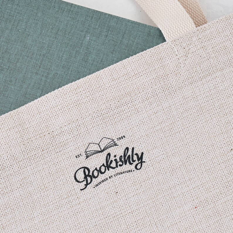 May include: A white canvas tote bag with a black logo that says "Bookishly" and "Est. 2009" with the text "Inspired by Literature" underneath.