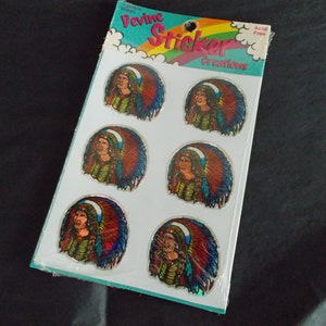 May include: A sheet of 6 holographic stickers featuring a Native American woman wearing a colorful headdress. The stickers are on a white background with the text "Divine Sticker Creations" and "Acid Free" printed on the sheet.