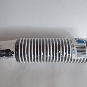 May include: A package of 25 white paper cups with a black silhouette of a bride and groom on the front. The cups are wrapped in plastic and have a barcode label with the text "USA" and "25CT" printed on it.