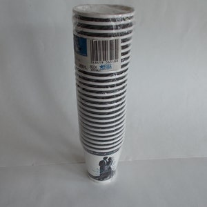 May include: A stack of 50 white paper cups with black stripes and a wedding couple design. The cups are wrapped in plastic and have a barcode label with the text "048419 005180".