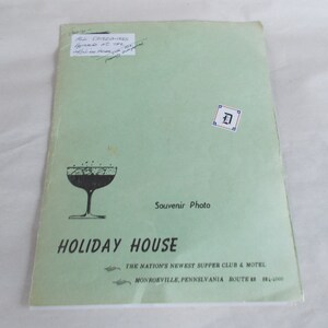 May include: A green pamphlet with the text "Holiday House" in black lettering. The pamphlet advertises a supper club and motel in Monrorville, Pennsylvania. The pamphlet also features a black and white illustration of a cocktail glass.