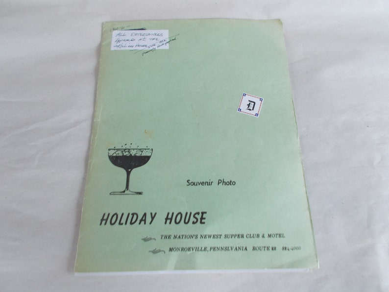 May include: A green pamphlet with the text "Holiday House" in black lettering. The pamphlet advertises a supper club and motel in Monrorville, Pennsylvania. The pamphlet also features a black and white illustration of a cocktail glass.