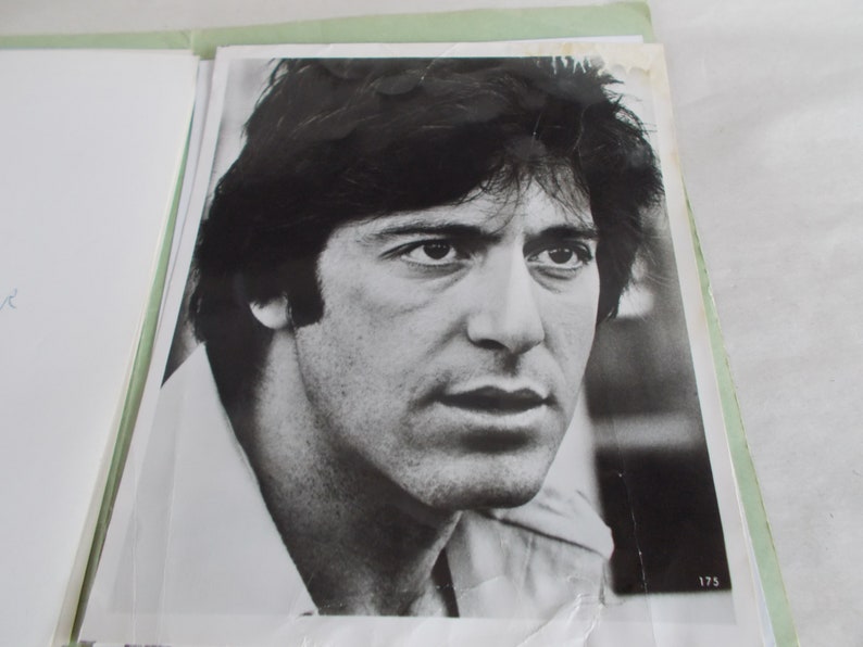 May include: Black and white photograph of a man with dark hair and a serious expression. He is wearing a collared shirt.