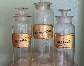 Antique apothecary bottles with gold glass labels