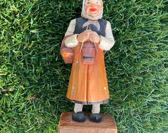 Carved wood figure of lady knitting