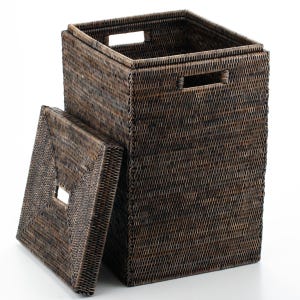 May include: A dark brown woven wicker hamper with a matching lid. The hamper is rectangular with a square opening at the top and cut-out handles. The lid has a square opening in the center. The hamper is designed for storage.