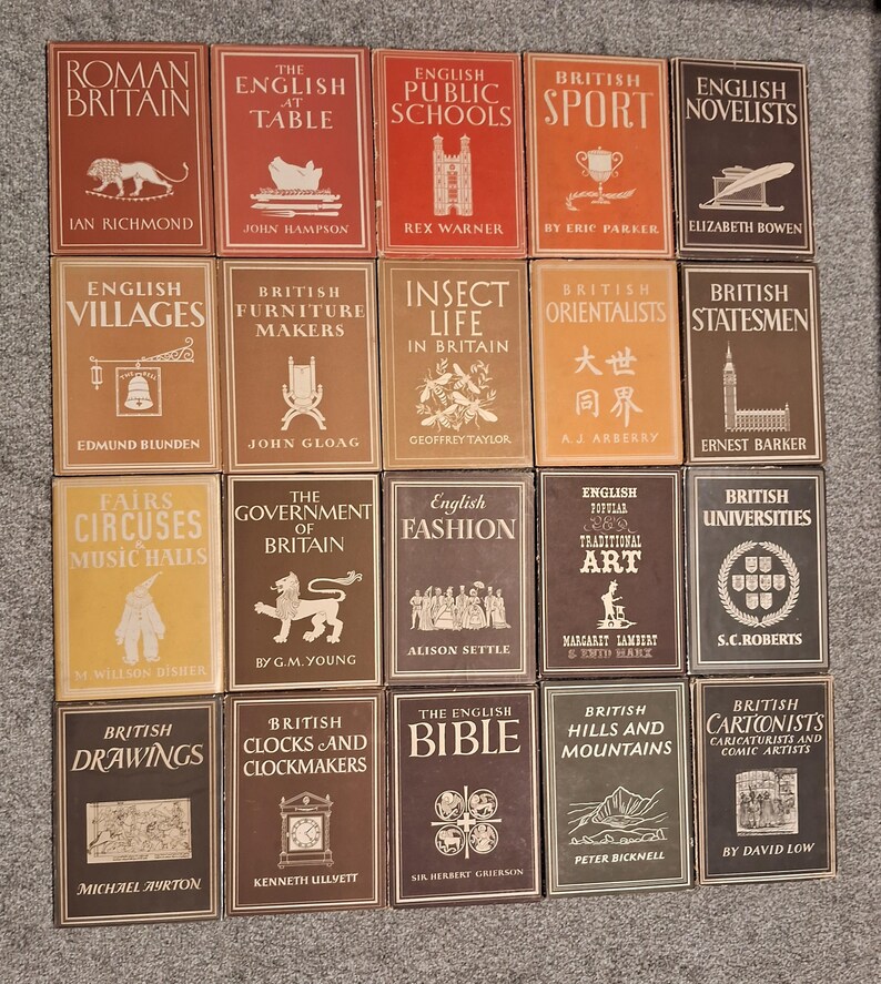 May include: A collection of 20 vintage hardback books with brown, red, and yellow covers. The books are arranged in four rows of five books each. The titles of the books include "Roman Britain", "The English Table", "English Public Schools", "British Sport", "English Novelists", "English Villages", "British Furniture Makers", "Insect Life in Britain", "British Orientalists", "British Statesmen", "Fairs Circuses Music Halls", "The Government of Britain", "English Fashion", "English Popular Traditional Art", "British Universities", "British Drawings", "British Clocks and Clockmakers", "The English Bible", "British Hills and Mountains", and "British Cartoonists Caricaturists and Comic Artists".