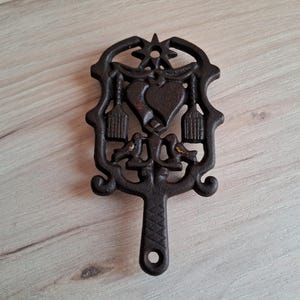 Wilton cast iron trivet, vintage trivet with hearts, love birds, brooms, sun, star, pot stand.
