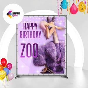 May include: A banner with the text "HAPPY BIRTHDAY ZOO" in purple. The banner features a cartoon gazelle wearing a purple fur coat. Colorful balloons and streamers are in the background. The Creative Store logo is in the upper left corner.