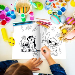 May include: A coloring book featuring Stitch and Lilo from Disney's Lilo & Stitch. The book is open to a page with black and white illustrations of Stitch and Lilo. A child is coloring the book with a blue marker.