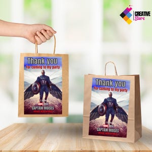 May include: Two brown paper gift bags with handles. Each bag has a printed label with a superhero character, the text "Thank you for coming to my party", and the words "I love Marvel Studios Captain Moises Brave New World".