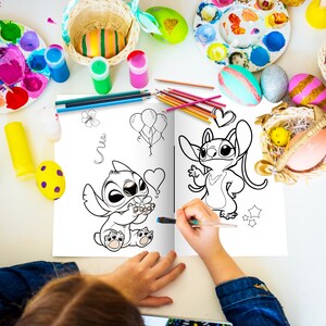 May include: A coloring book open to two pages featuring black and white line drawings of Stitch from Lilo & Stitch. The left page shows Stitch holding a flower and the right page shows Stitch with a heart above its head. A child is coloring the book with a blue marker.