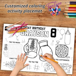 May include: A black and white coloring placemat with a boxing theme. It features a word search, connect the dots, tic-tac-toe, and a maze. The placemat is personalized with the name "Grayson" and the number "8".