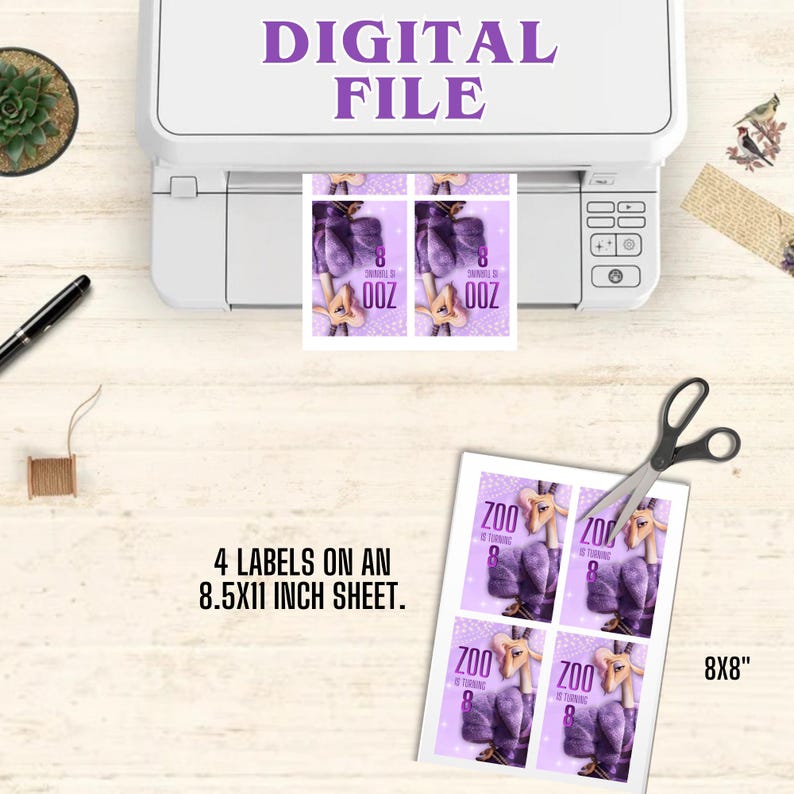 May include: A printer with the text "DIGITAL FILE" prints labels with a purple and white design. The labels read "ZOO" and "8" and are on an 8.5x11 inch sheet. A pair of scissors and a ruler are also visible.
