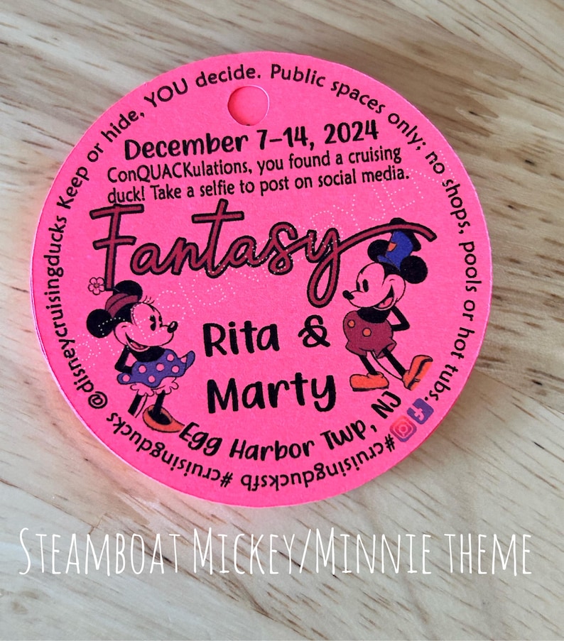 May include: A circular bright pink tag featuring cartoon mice characters, the text "Fantasy", "Rita & Marty", "Egg Harbor Twp, NJ", and "December 7-14, 2024". The tag includes social media icons and instructions for a cruising duck activity.