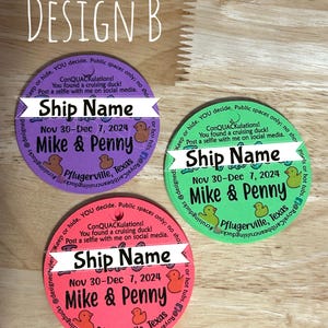May include: Three circular tags in purple, green, and pink, each featuring the text Design B, Ship Name, ConQUACkulations, You found a cruising duck, Post a selfie with me on social media, Nov 30-Dec 7, 2024, Mike & Penny, and Pflugerville, Texas.