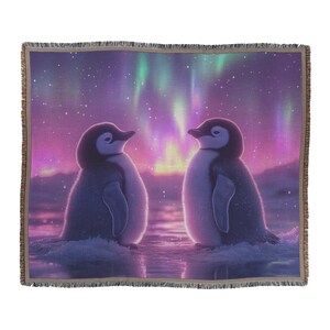 Two Penguins Huddling Together Under Glowing Aurora Sky with Intricate Snow Details and Vibrant Colors Woven Throw Blanket