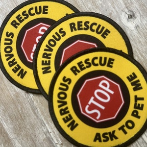 May include: Three yellow and black round patches with the text "NERVOUS RESCUE" and a red stop sign with the text "STOP" in the center. The bottom patch also has the text "ASK TO PET ME".