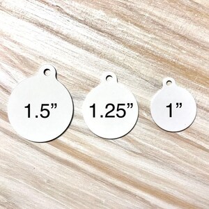May include: Three round metal tags with different sizes: 1.5 inches, 1.25 inches, and 1 inch. Each tag has a hole at the top for attaching.