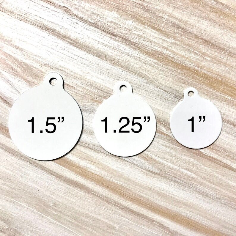 May include: Three round metal tags with different sizes: 1.5 inches, 1.25 inches, and 1 inch. Each tag has a hole at the top for attaching.