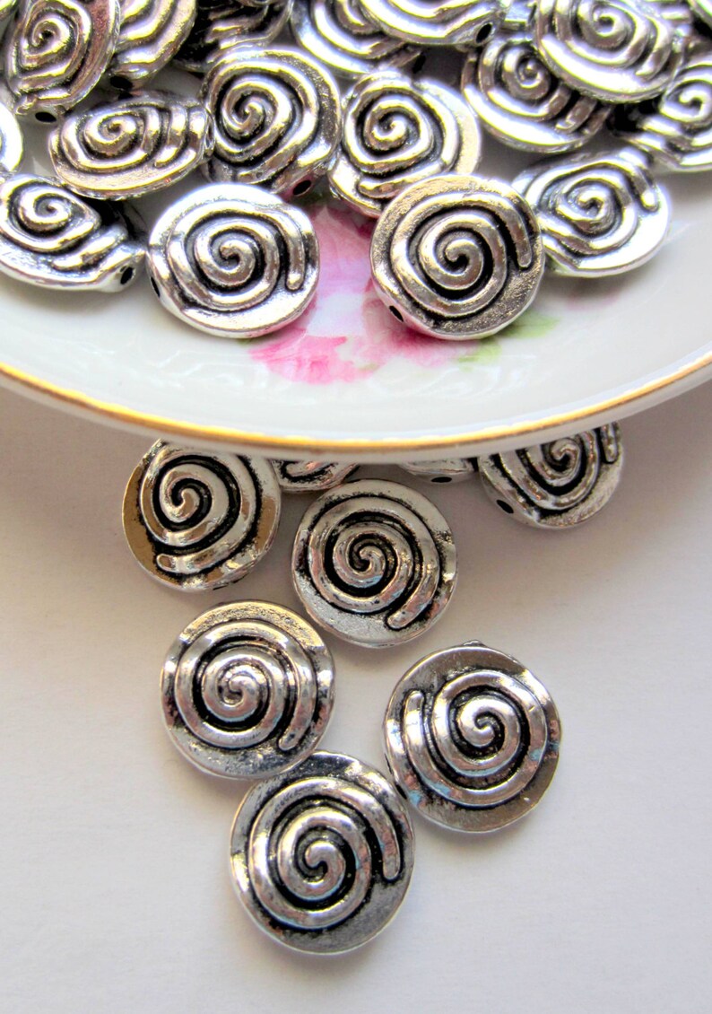 24 Silver beads swirl pattern focals antique silver ...
Vintage Swirl Patterns