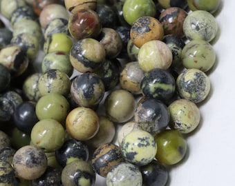 May include: A strand of green, brown, and black gemstone beads. The beads are round and have a mottled appearance.