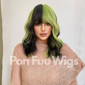 May include: A woman wearing a black and green wig with a side part and bangs. The wig has a wavy texture and is styled with a half-and-half color scheme. The text "Pon Fuu Wigs" is printed on the front of the image.
