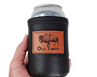 May include: Black leather can cooler with a brown leather patch featuring a buffalo silhouette and the text "Old Timer".