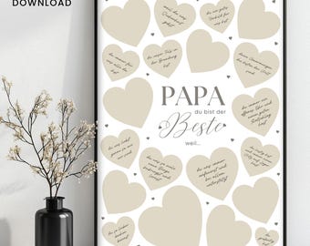 May include: A framed print with a white background and beige hearts. The text "PAPA du bist der Beste" is in the center, with additional text inside the hearts. A black vase with white flowers is in the foreground.