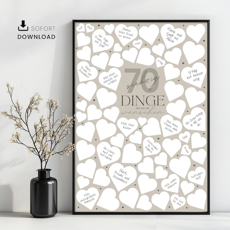 May include: A framed print with a beige background and numerous white heart shapes. The print features the number "70" and German text, with the word "SOFORT DOWNLOAD" in the upper left corner. A black vase with a plant is in the foreground.