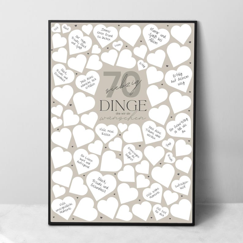 May include: A framed print with a beige background and numerous white heart shapes. The print features German text, including the number "70" and the words "Dinge die wir dir w&uuml;nschen," which translates to "70 things we wish you."