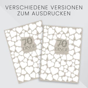 May include: Two greeting cards with a beige background covered in white hearts. The cards have the text "70 things I wish you" in gray and black. The top of the image has the text "Various versions to print".