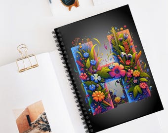 May include: A black spiral notebook with a colorful floral design forming the letter "H".