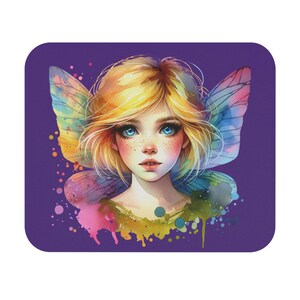 May include: A square purple mousepad featuring a watercolor illustration of a fairy. The fairy has blonde hair, blue eyes, and colorful wings. Splatters of paint in pink, yellow, and green surround the fairy.