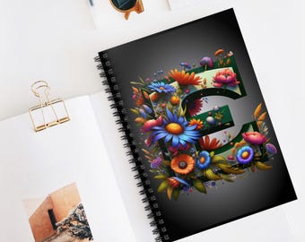May include: A black spiral notebook with a colorful floral design featuring the letter "E" in the center. The flowers are in shades of blue, red, orange, yellow, and green.