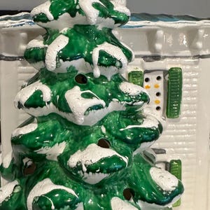 K&ouml;nnte beinhalten: Eine Keramik-Weihnachtsbaumfigur mit gr&uuml;ner und wei&szlig;er Glasur. Der Baum hat einen verschneiten, gefrorenen Look und ist mit kleinen L&ouml;chern verziert.