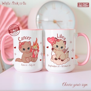 May include: Two white ceramic mugs with pink handles and rims. One mug features a cartoon cat labeled "Cancer" with a gift, the other "Libra" with a heart balloon. The mugs are 15 oz and have the text "Choose your sign".