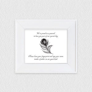 May include: A white framed guest book sign with text and a peacock feather illustration. The text reads, "We're proud as a peacock to have you part of our special day. Please leave your fingerprint and sign your name inside a feather on our guest book."